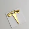 Tesla ratt emblem guld