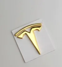 Tesla ratt emblem guld